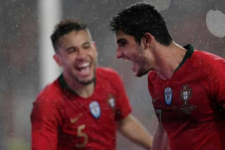 Portugal's Goncalo Guedes (right) celebrating one of his two goals with Raphael Guerreiro.