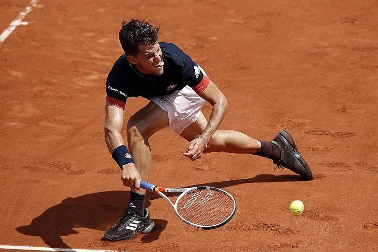 Austrian seventh seed Dominic Thiem scrambles for a forehand during his 7-5, 7-6 (12-10), 6-1 victory against unseeded Marco Cecchinato of Italy yesterday. Cecchinato eliminated three seeds, including Novak Djokovic, during his electrifying run to th