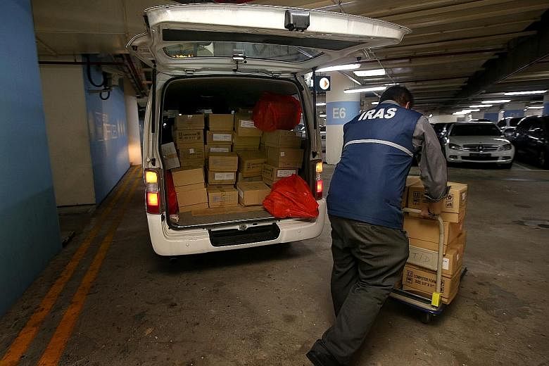 Iras forensic officers unloading documents and other evidence from a van at Revenue House after a raid on a firm.