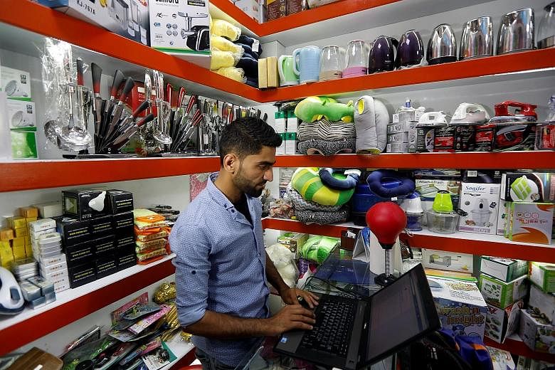 A shopkeeper using his laptop to check on his online store in Kabul, where suicide bombings and other attacks have killed and wounded hundreds of people this year, and where sexual harassment on the street is widespread. Such start-ups are doing bris