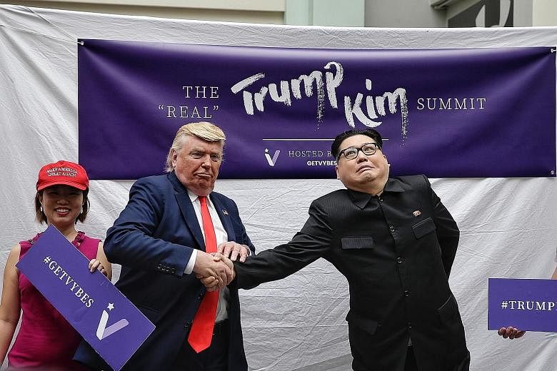 Trump impersonator Dennis Alan giving Kim Jong Un impersonator Howard X a firm handshake, at their meet and greet with fans yesterday.