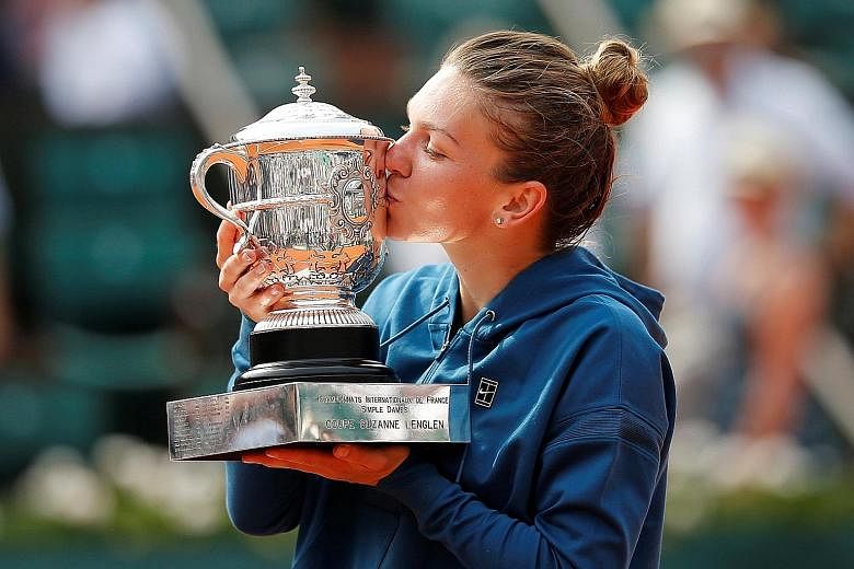 Simona Halep celebrating by getting her hands and lips on her first Grand Slam trophy after rallying to win 3-6, 6-4, 6-1 against reigning US Open champion Sloane Stephens in yesterday's French Open final. The world No. 1 had lost her three previous 