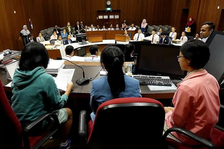 Secondary school students role-playing in a mock trial as part of the "A Day In Court" seminar, organised by the State Courts of Singapore. The participants took up their roles with utmost gravity as they had to decide the offender's punishment, whil