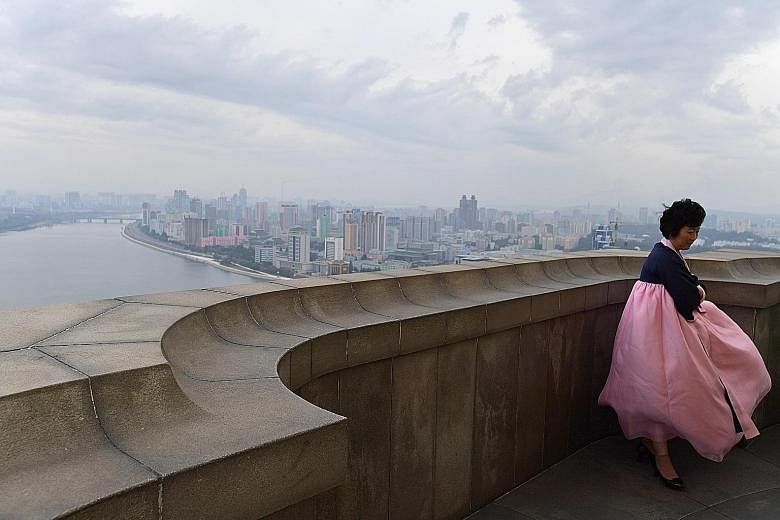 An official tour guide fighting strong winds at the top of Juche Tower in Pyongyang. If North Korea and the US do manage to find common ground, this could gradually open up rich new possibilities for Pyongyang.
