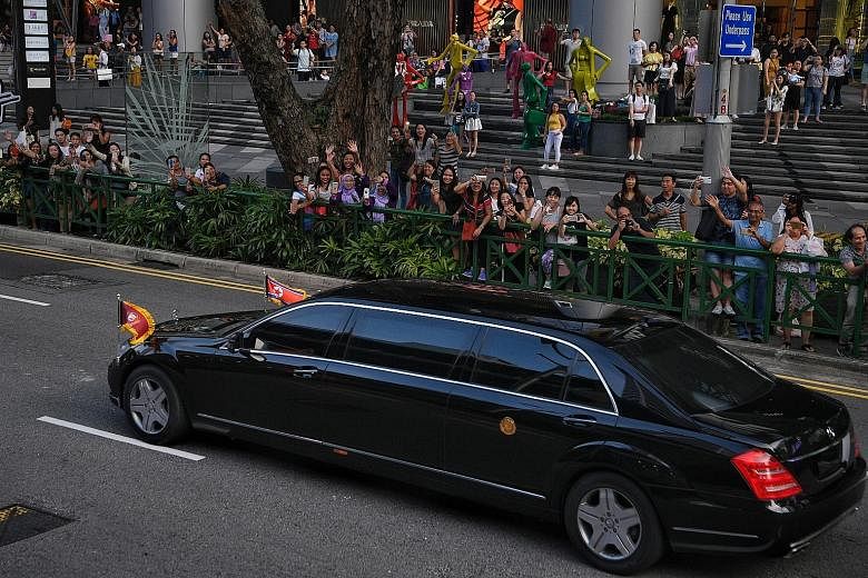 Onlookers lining Orchard Road to catch a glimpse of North Korean leader Kim Jong Un's vehicle convoy as it travelled past Ion Orchard mall on its way to the Istana, where he met Prime Minister Lee Hsien Loong yesterday.