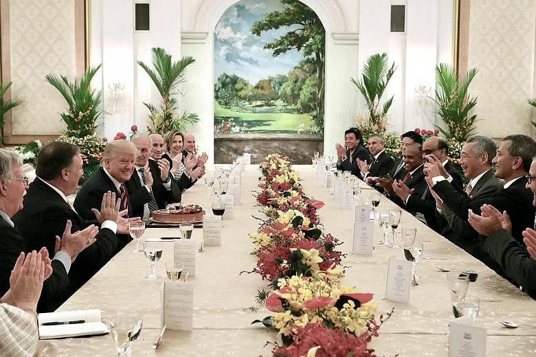 Mr Trump meeting PM Lee at the Istana yesterday, where they discussed a wide range of regional and global developments. US President Donald Trump smiling after he blew out a candle on his birthday cake during lunch with Prime Minister Lee Hsien Loong