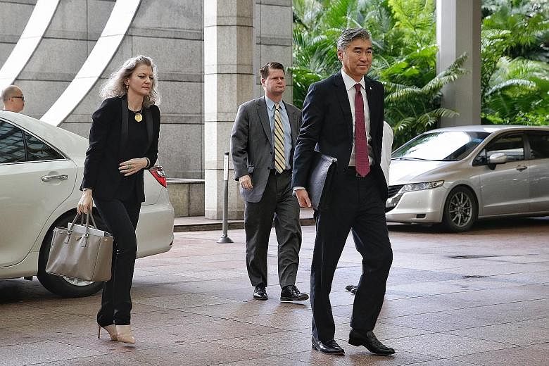 American officials (left), led by US Ambassador to the Philippines Sung Kim, and North Korean officials (right), led by the country's Vice-Foreign Minister Choe Son Hui, arriving at The Ritz-Carlton, Millenia Singapore yesterday morning for working-l