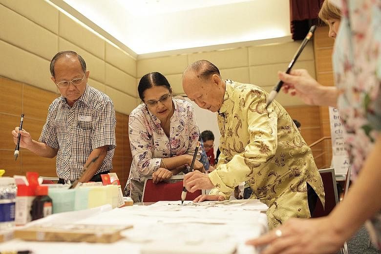 (From left) Workshop participants Tan Boon Soon and Nimmi Suresh with artist Tan Khim Ser.