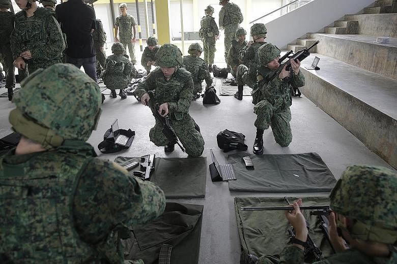 Recruits undergo weapon-handling training with the SAR21 rifle at the Singapore Armed Forces Basic Military Training Centre on Pulau Tekong. Closed to the public since 1987, the island is now a permanent military base used for the training of new nat