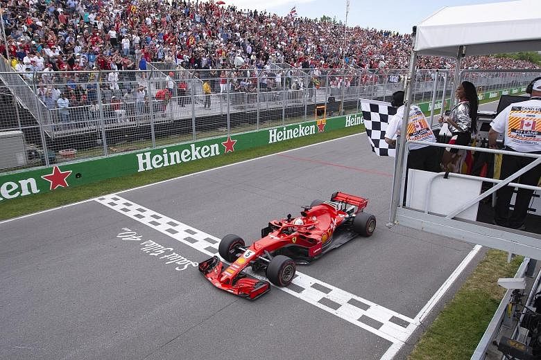 Ferrari's Sebastian Vettel driving across the finishing line under the chequered flag for the second time to win the Canadian Grand Prix in Montreal on Sunday. Model Winnie Harlow had earlier mistakenly waved the flag one lap too early, allegedly und