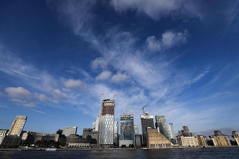 The Canary Wharf district in London. One measure of a city's confidence and attractiveness is the number of cranes adorning its skyline as new office buildings are constructed. While skyscrapers are still springing up in London, Paris has embarked on
