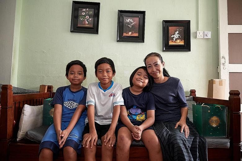 Madam Aminah Delima Rais and her children - (from left) Mohd Syahmirul Danish, 10; Mohd Syahqirin Daniel, 12; and Nur Syahirah Putri Dania, eight - will be able to repaint their flat ahead of Friday's Hari Raya, thanks to a cash donation and hampers 