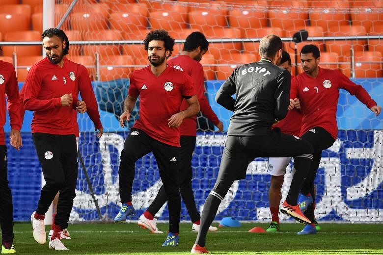 Egypt's Mohamed Salah (second from left) is "almost 100 per cent" certain to play against Uruguay, according to national coach Hector Cuper, despite the forward's shoulder injury suffered in Liverpool's Champions League final defeat by Real Madrid on