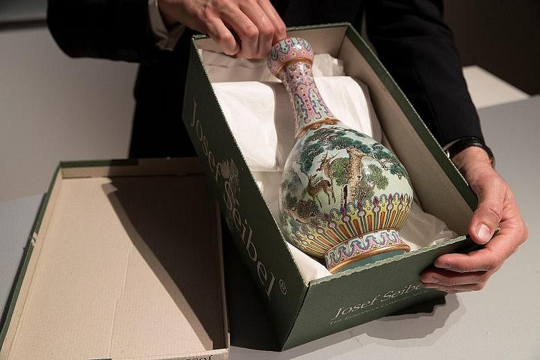 Attic antique: Experts had expected this exquisite porcelain vase made for Qing Dynasty Emperor Qianlong to go for a modest €500,000. Instead, it sold for more than 30 times the estimated price at Sotheby's in Paris on Tuesday.