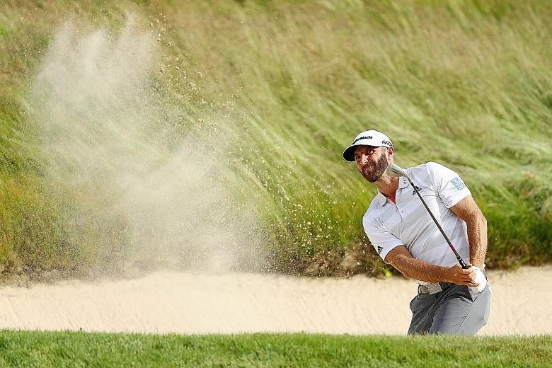World No. 1 Dustin Johnson of the United States playing a bunker shot on the 14th hole during the first round of the 2018 US Open at Shinnecock Hills Golf Club on Thursday. He carded a one-under 69.