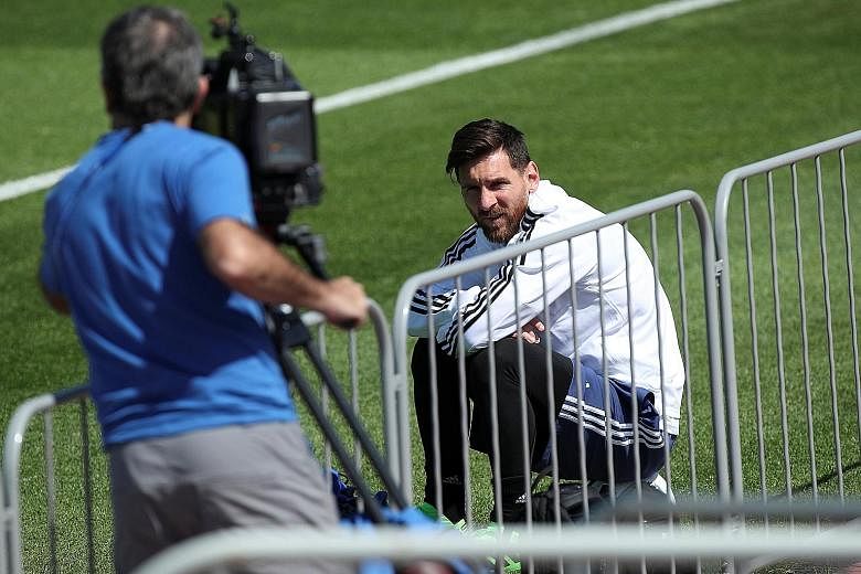 Lionel Messi taking a break during Argentina's training session yesterday. His team-mates have vowed to do everything in their power to give their talisman the World Cup success he craves.
