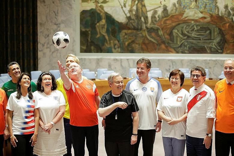 Members of the UN Security Council, including Russian Ambassador Vassily Nebenzia (with ball) and UN Secretary-General Antonio Guterres (in black), posing for a photo to mark the opening match of the World Cup on Thursday.