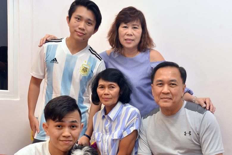 Ms Helen Agpato (centre) with Mrs Jenny Lee, Mr Roland Lee and their sons Cornelius (standing), 22, and Jordan, 27. The 61-year-old maid has worked for the Lee family for 24 years.