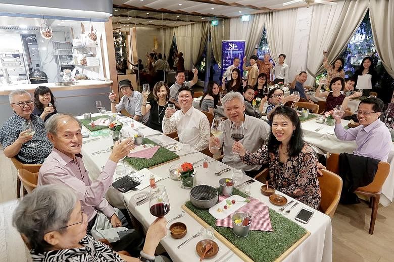 Six ST readers and their families enjoying a Father's Day dinner treat at Curate restaurant at Resorts World Sentosa. The meal boasted a showcase menu by chef Benjamin Halat and was hosted by Straits Times food critic Wong Ah Yoke.