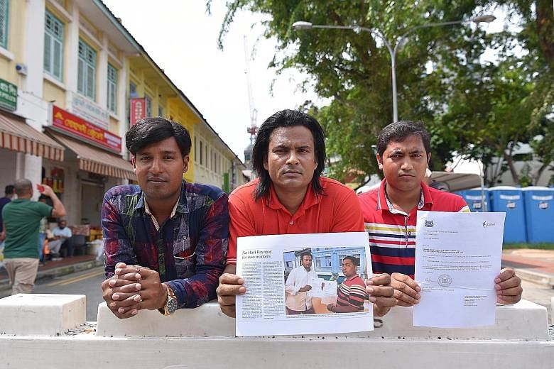 Bangladeshi workers (from left) Rabiul Islam Abdur Rahaman Mia, Alam Ataur Rahman and Islam Mohd Rubayet with copies of the ST story in 2016 on their plight and the Labour Court Order.