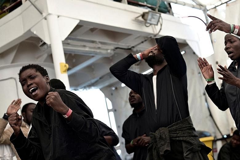 Migrants singing on the deck of the Aquarius as it makes its way to Spain. The passengers come from 26 countries, mainly from Africa but also Afghanistan, Bangladesh and Pakistan, according to Doctors Without Borders.