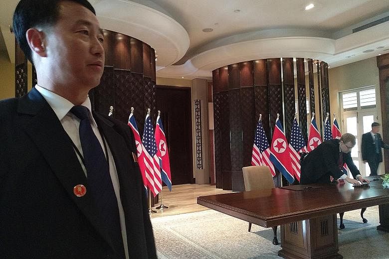 A North Korean cameraman outside The St Regis Singapore hotel, where leader Kim Jong Un stayed. The country's camera crew had earned themselves a reputation for photobombing at the inter-Korea summit in April. A North Korean security agent guarding t