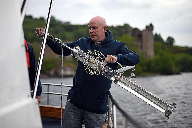 Professor Neil Gemmell takes samples on his boat as he conducts research into the DNA present in the waters of Loch Ness in the Scottish Highlands. Tales and reported sightings of a giant creature in the waters have been around for over 1,500 years.