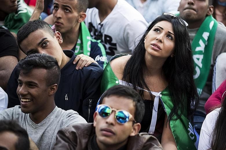 A woman enjoying her day out among the Saudi Arabia supporters as they watch the 2018 World Cup's opening match last Thursday between their team and hosts Russia in Moscow's Luzhniki Stadium.