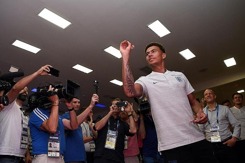 England midfielder Dele Alli taking part in a darts competition in Repino, Russia, on Saturday. His on-field skills typify Gareth Southgate's young and dynamic group of players.
