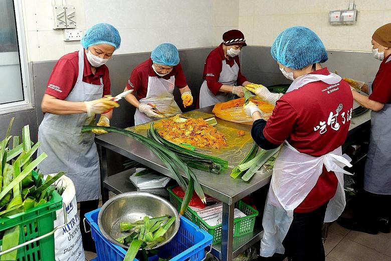 SMH Foods Enterprise staff prepare Thai pandan leaves chicken. Food manufacturers such as Golden Bridge and SMH had to construct separate manufacturing facilities to ensure their food would not be contaminated with non-halal sources.