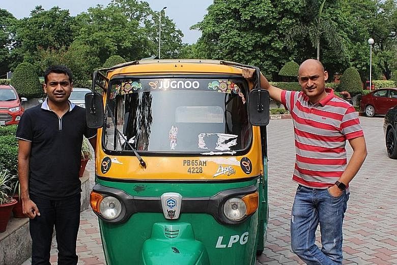 Jugnoo co-founders Chinmay Agarwal (left) and Samar Singla with an auto-rickshaw outside their office in Chandigarh. Its Indian business is built on hailing auto-rickshaws instead of offering cab rides.