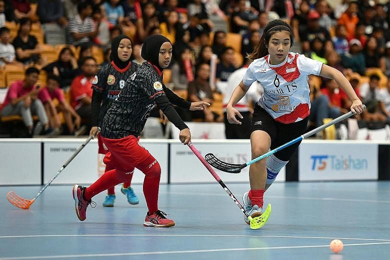 Singapore's Mindy Lim fighting for the ball with Indonesia's Ayu Danita Heristika. The Republic's team scored a resounding 18-0 victory over the visitors yesterday.