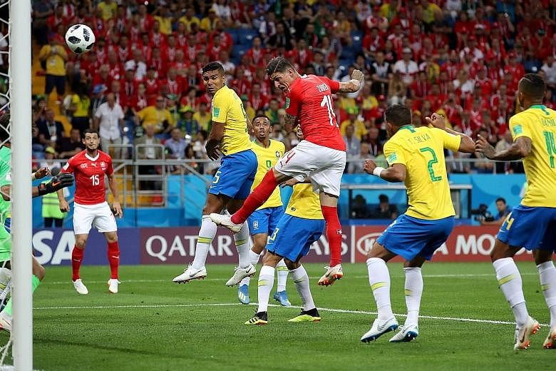 Steven Zuber outleaping Miranda (unsighted) to head home Switzerland's equaliser against Brazil, who felt that Zuber had pushed their player.