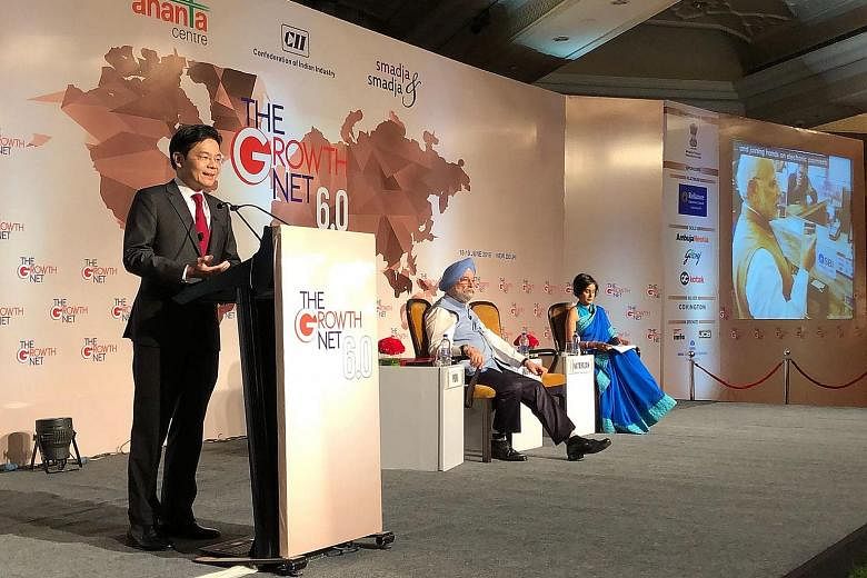 Mr Lawrence Wong speaking at the convention, sharing the stage with Mr Hardeep Singh Puri, India's minister of state for housing and urban affairs, and Ms Manisha Natarajan, the moderator.