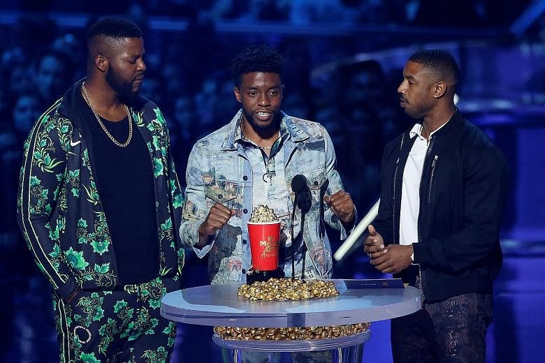Actors (from left) Winston Duke, Chadwick Boseman and Michael B. Jordan accept the Best Movie award for Black Panther at this year's MTV Movie & TV Awards.