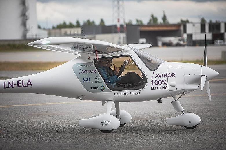 Norwegian Transport Minister Ketil Solvik-Olsen (left) and pilot Dag Falk-Petersen, head of state-run Avinor, preparing to take off in an Alpha Electro G2 electric two-seater plane for its inaugural flight on Monday.