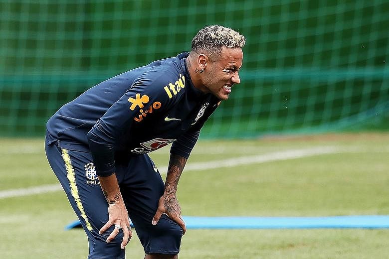 Neymar grimacing during training yesterday before hobbling out with a "painful right ankle". A spokesman for the Brazilian federation attributed the knock to the 10 fouls on the star forward during Sunday's 1-1 draw with Switzerland.