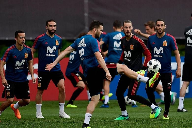 Spain defender Nacho Fernandez, who scored what could have been the winner until Cristiano Ronaldo struck for Portugal in their 3-3 draw last Friday, controlling the ball as goalkeeper David de Gea and other team-mates watch during training at the Kr