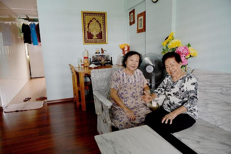 Madam Tan Gek Bee (far left, with her neighbour Soh Ah Tung) moved back to MacPherson Lane (above) in 2004 as she missed the area. The women now meet at Madam Tan's flat up to four times a week to chat.