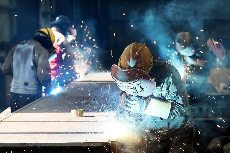 A worker cutting steel at a factory in Huaibei, in China's Anhui province. US President Donald Trump's threat of additional tariffs on US$200 billion (S$272 billion) worth of Chinese goods comes after the US announced 25 per cent additional tariffs o