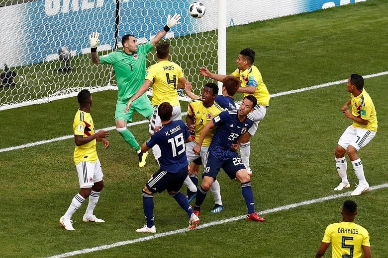 Japan's Yuya Osako (third from right) scoring their second goal, which sealed a 2-1 win over Colombia in their World Cup Group H match at the Mordovia Arena in Saransk yesterday.