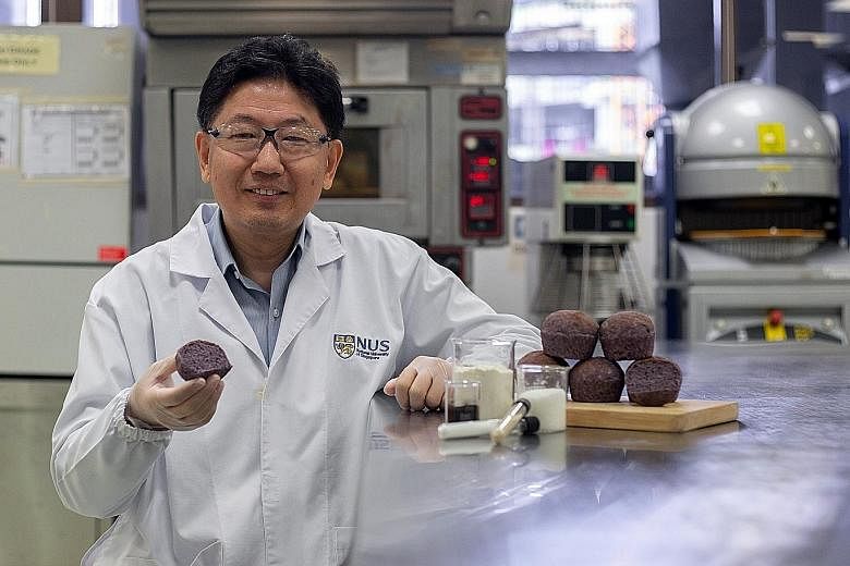 Professor Zhou Weibiao with diabetic-friendly bread that contains a natural plant pigment called anthocyanin. This purplish bread tastes like white bread but can be digested at a slower rate, hence improving blood glucose control.