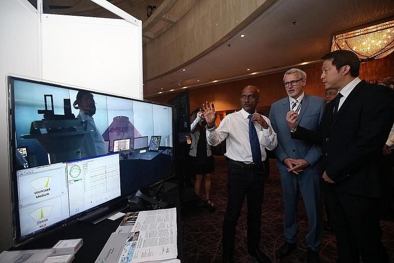 (From left) Captain Gopala Krishnan, research lead for the Centre of Excellence in Maritime Safety; Dr Wolfgang Müller-Wittig, executive director of Fraunhofer Singapore; and Senior Minister of State for Transport and Health, Dr Lam Pin Min, viewing