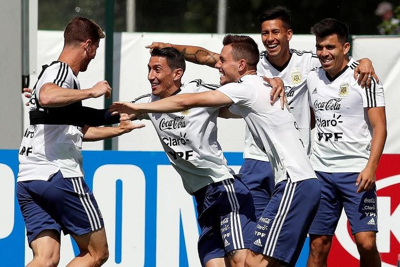 Angel di Maria (second from left) having a light moment with team-mates during an Argentina training session yesterday. La Albiceleste face Croatia today knowing they need to get two tasks right: supporting their talisman Lionel Messi and clinching v