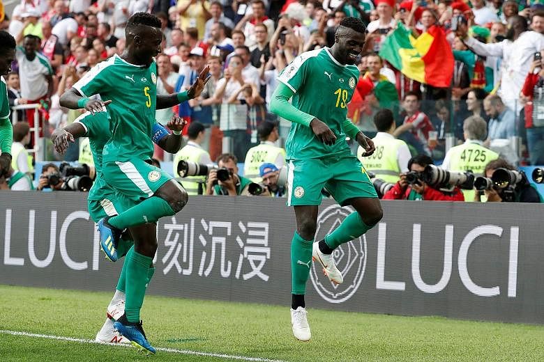 Senegal's M'Baye Niang (right) does a victory dance with Idrissa Gueye after scoring the winner in the 2-1 win over Poland on Tuesday. The Africans are level on three points at the top of Group H with Japan, who they will face next on Sunday.