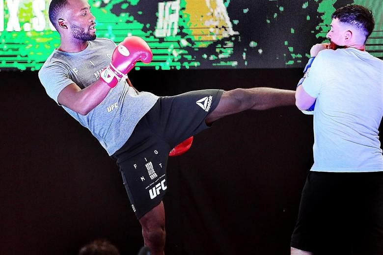 Leon Edwards working out with his trainer ahead of tonight's UFC Fight Night Singapore event at the Indoor Stadium, where his opponent Donald "Cowboy" Cerrone is going for a record 21st UFC victory.