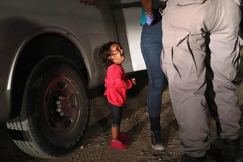 The Honduran toddler crying as her mother was being searched near the US-Mexico border on June 12. Mother and child have been detained together.