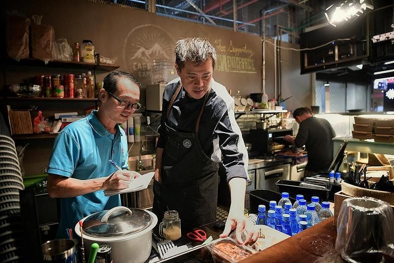 Former prison officer Hilary Lo (left) is now The Caffeine Experience's operations manager, while former drug dealer Matthew Poh handles the front end of the business as the cafe's administrator.