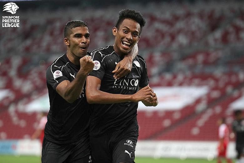 Home United's M. Anumanthan celebrating with Iqram Rifqi after the latter's 90th-minute equaliser in the Singapore Premier League match against the Young Lions at the National Stadium last night.