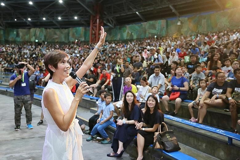 HomeTeamNS president Josephine Teo, who is Manpower Minister, speaking to some 5,000 HomeTeamNS members, volunteers and their families at the inaugural family day event at Universal Studios yesterday.